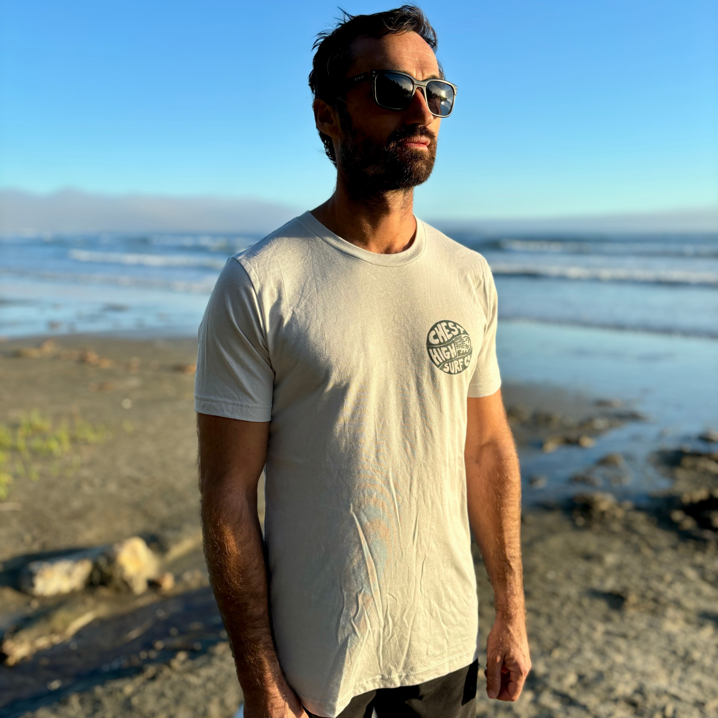 Surfer wearing a Chest High graphic tee on the West Coast.