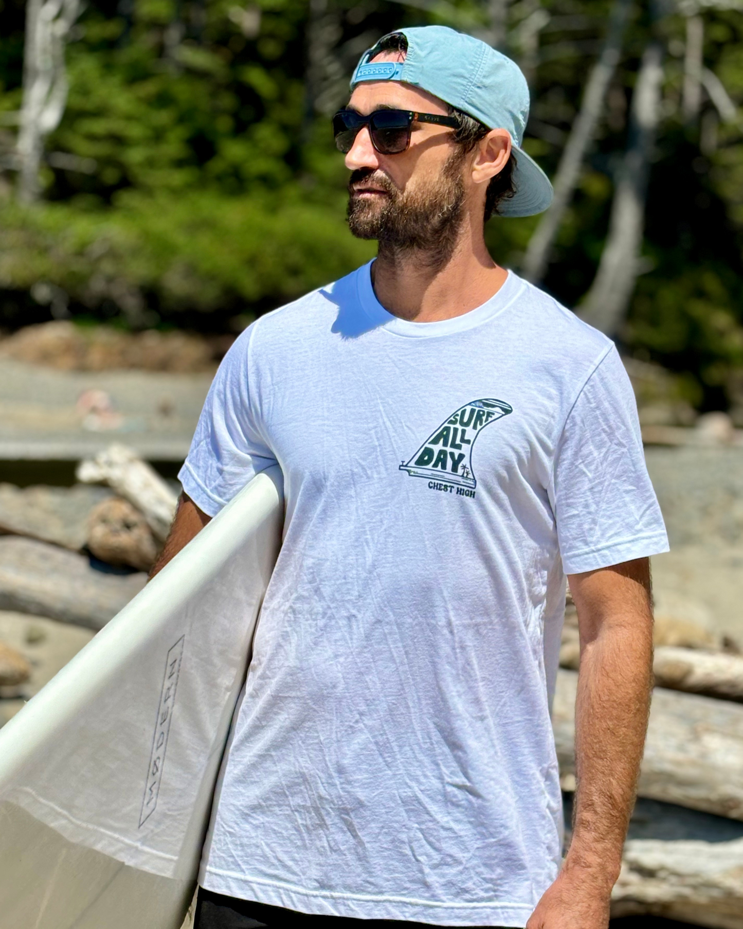 Surfer wearing a single fin graphic tee on the West Coast.